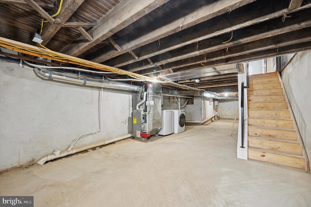 basement featuring separate washer and dryer and heating unit