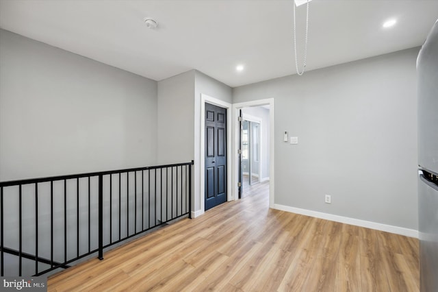 spare room featuring light hardwood / wood-style floors