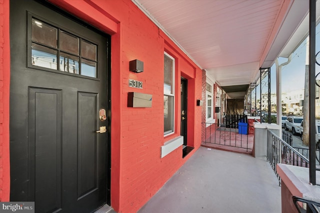 doorway to property featuring covered porch