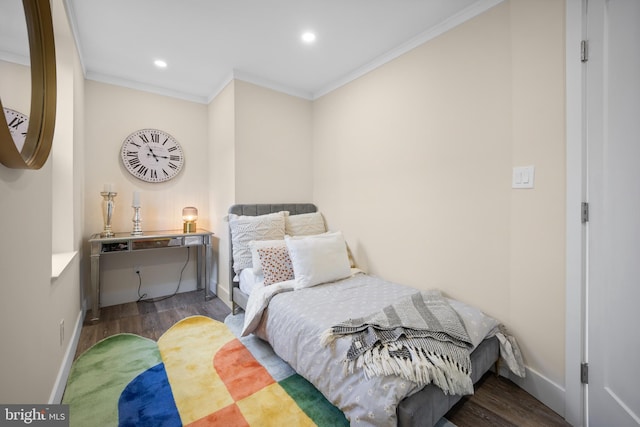 bedroom with hardwood / wood-style floors and crown molding