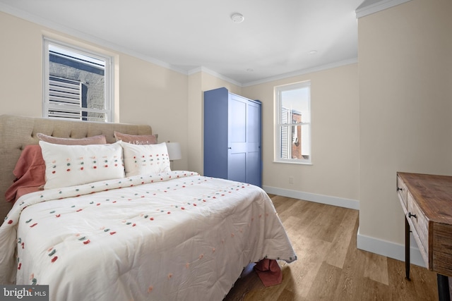 bedroom featuring ornamental molding and light wood-type flooring