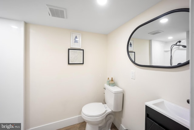 bathroom featuring hardwood / wood-style flooring, vanity, and toilet