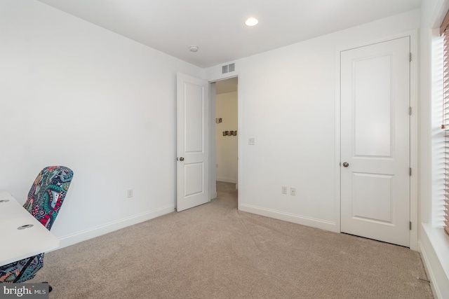 unfurnished office featuring light colored carpet