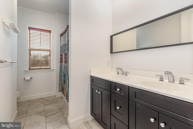 bathroom with tile patterned floors, vanity, and toilet