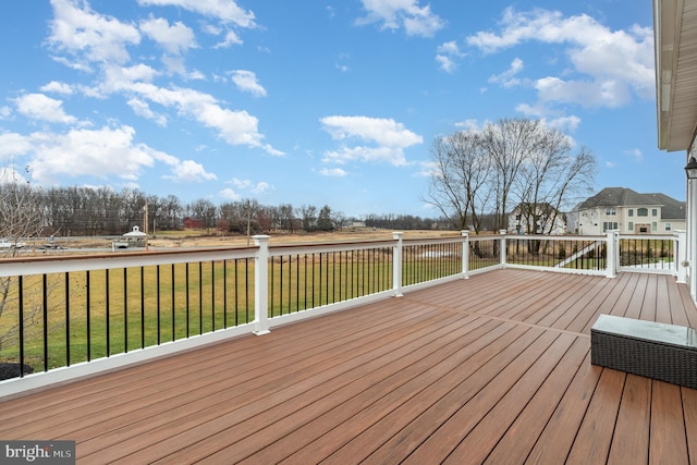 wooden terrace featuring a yard