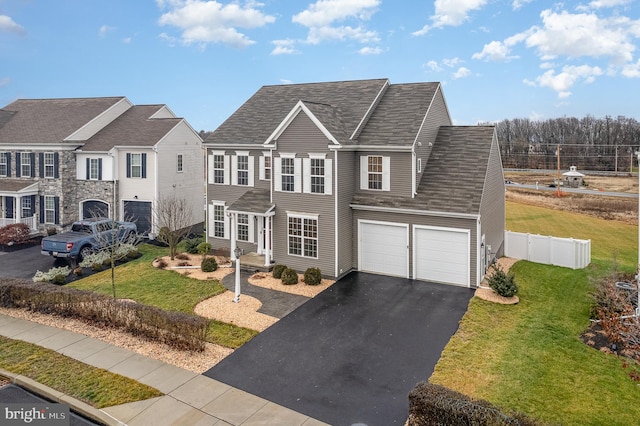 view of front of house featuring a front lawn and a garage