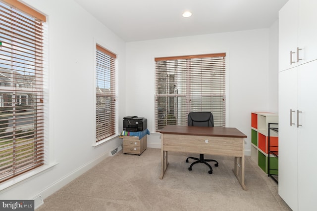 carpeted home office with a healthy amount of sunlight