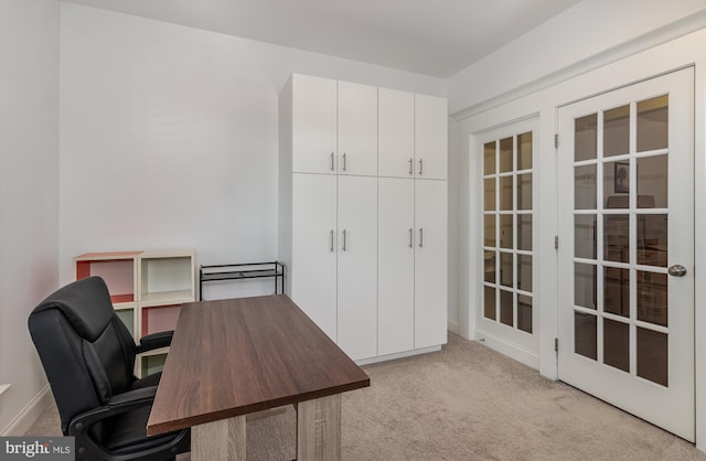 carpeted office space featuring french doors