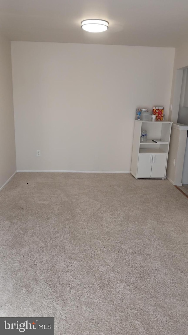 spare room featuring light colored carpet