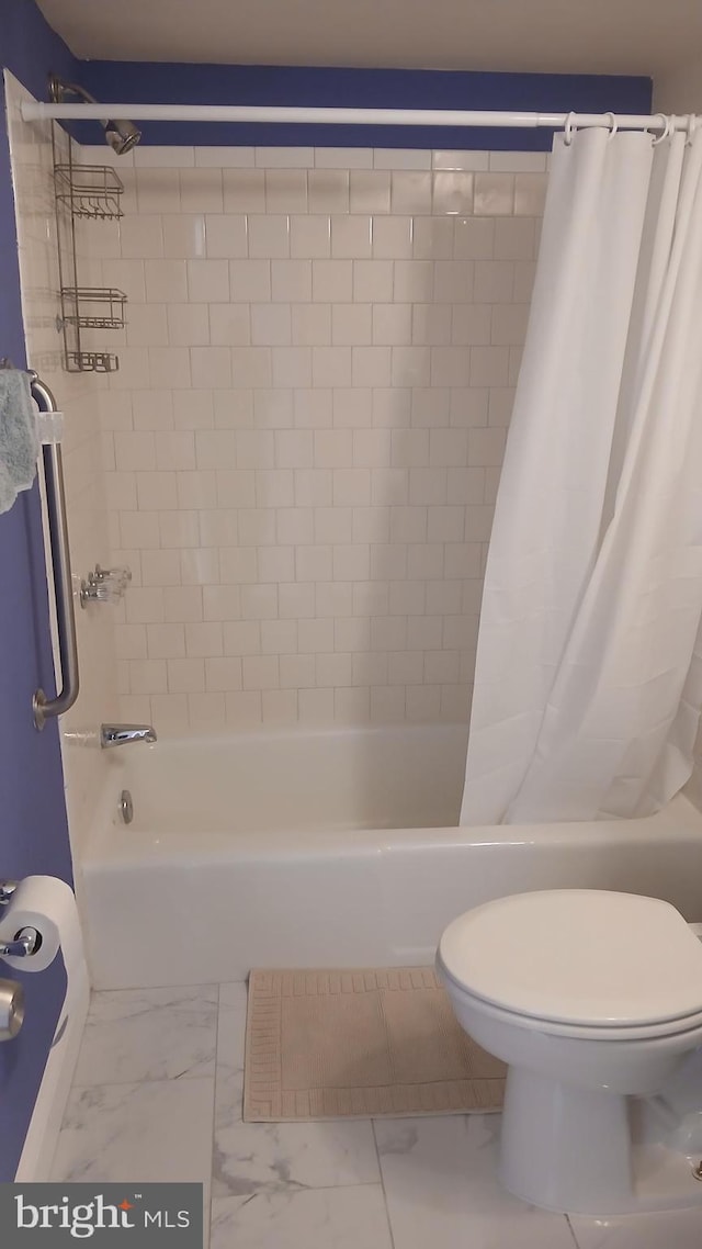 bathroom with toilet and shower / tub combo with curtain