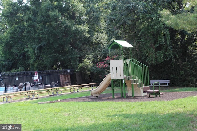 view of playground with a lawn