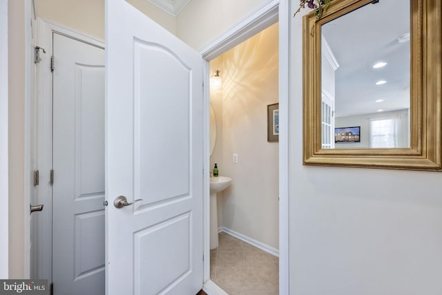 bathroom with tile patterned flooring and crown molding