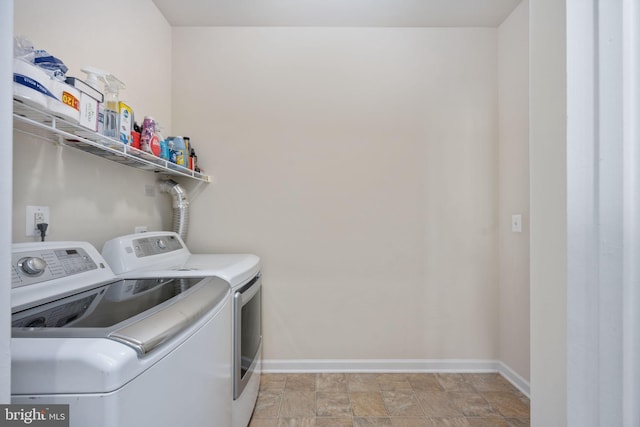 laundry room featuring washing machine and clothes dryer