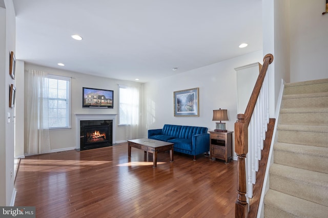 living room featuring dark hardwood / wood-style flooring and a healthy amount of sunlight