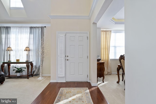 foyer entrance featuring hardwood / wood-style floors and crown molding