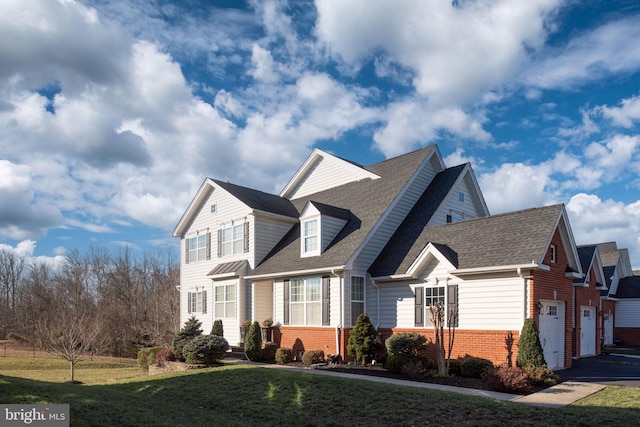 view of front facade with a garage and a front lawn