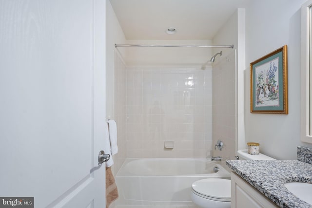 full bathroom with toilet, vanity, and tiled shower / bath combo