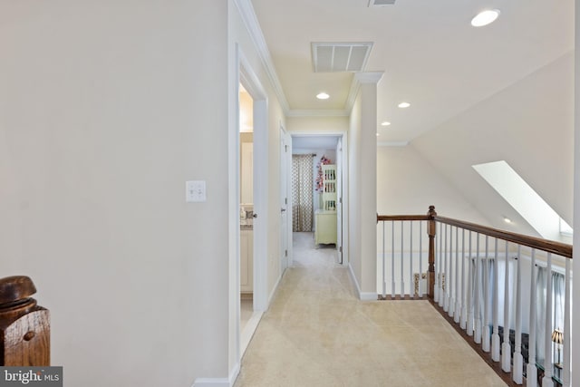 corridor featuring light colored carpet and crown molding