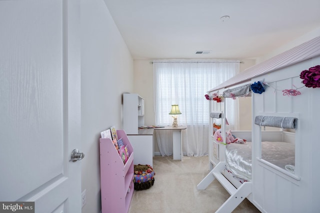 bedroom with light colored carpet