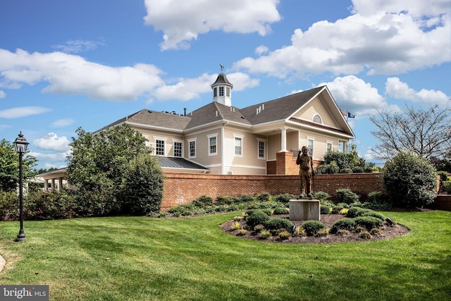 back of property featuring a lawn