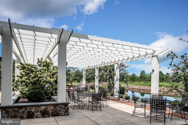 view of patio featuring a pergola and a water view