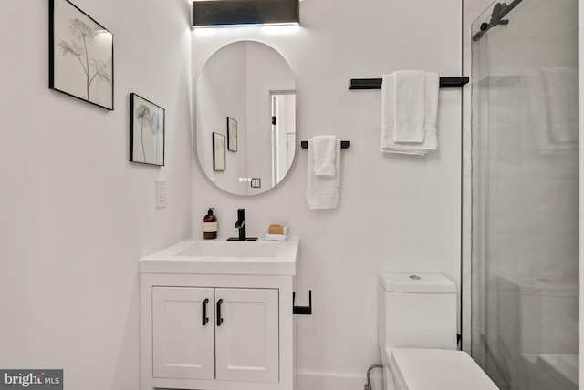 bathroom featuring vanity, toilet, and walk in shower