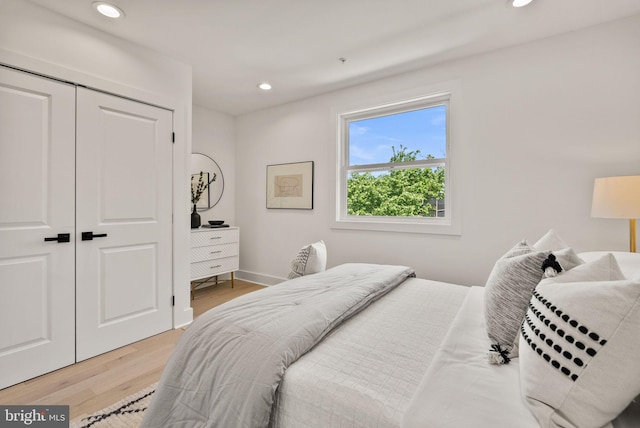 bedroom with a closet and hardwood / wood-style floors