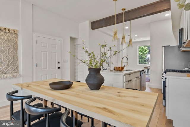 dining room with light hardwood / wood-style floors and sink