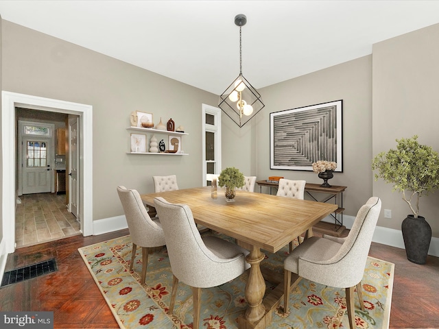 dining area with dark parquet floors