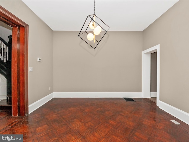 unfurnished dining area featuring dark parquet flooring