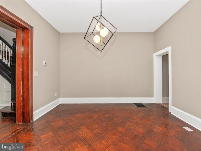 unfurnished dining area with dark parquet floors