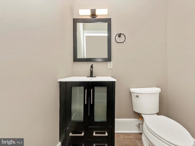 bathroom with tile patterned flooring, vanity, and toilet