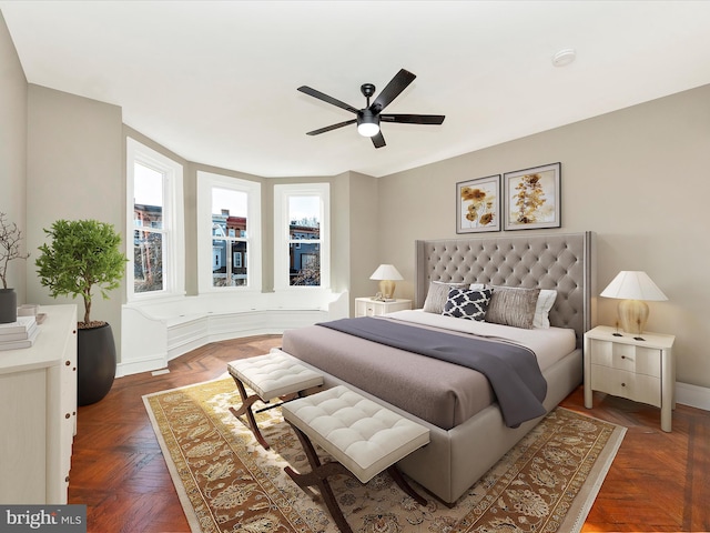 bedroom with dark parquet floors and ceiling fan