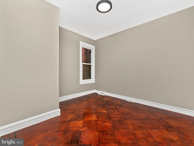 unfurnished room featuring parquet flooring