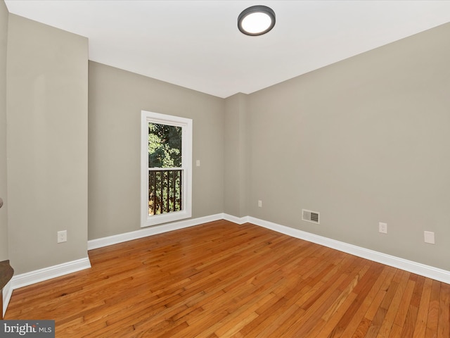 spare room with hardwood / wood-style floors