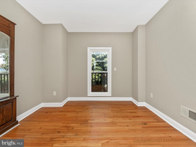 unfurnished room with light wood-type flooring