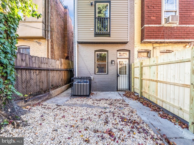 property entrance featuring central air condition unit, a patio area, and cooling unit