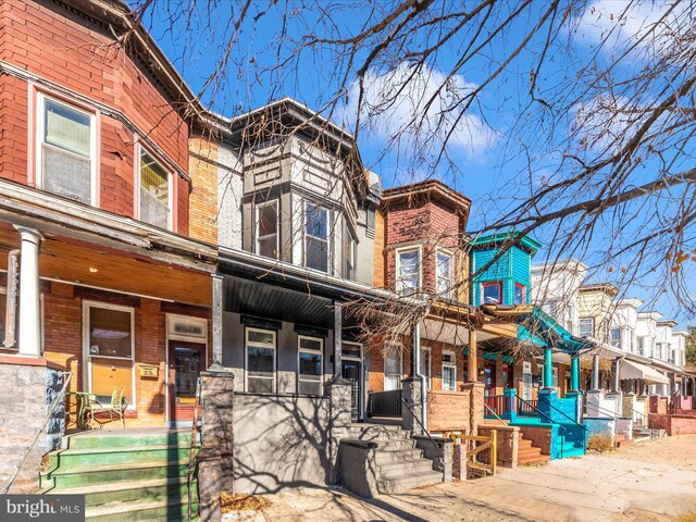 310 E 25th St, Baltimore, MD 21218 - view of front of home with a porch and brick siding