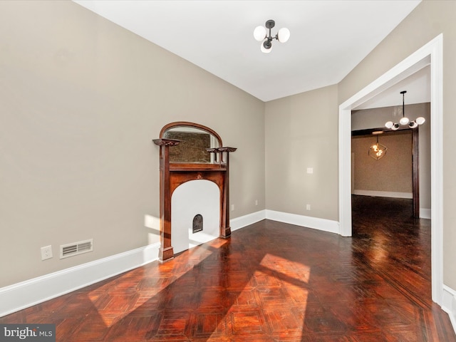 310 E 25th St, Baltimore, MD 21218 - unfurnished living room with a chandelier, baseboards, and a fireplace