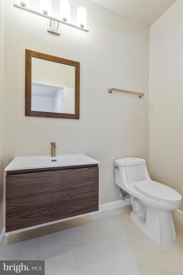 bathroom with tile patterned floors, vanity, and toilet