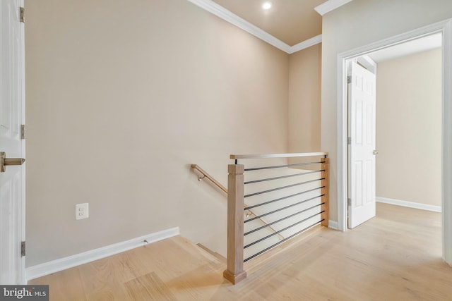 staircase featuring crown molding and hardwood / wood-style floors