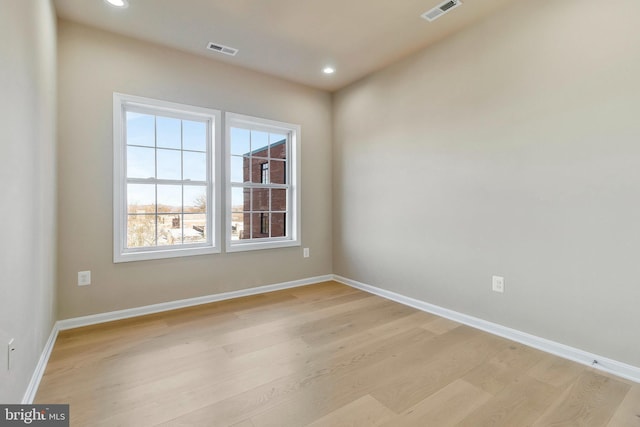 spare room with light hardwood / wood-style flooring