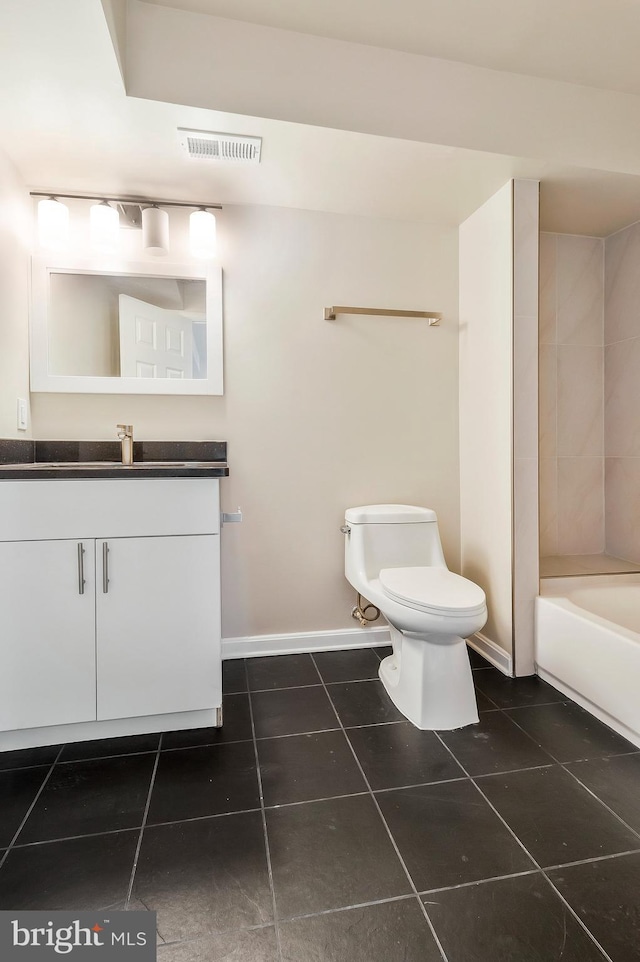 full bathroom with tile patterned flooring, vanity, tiled shower / bath combo, and toilet