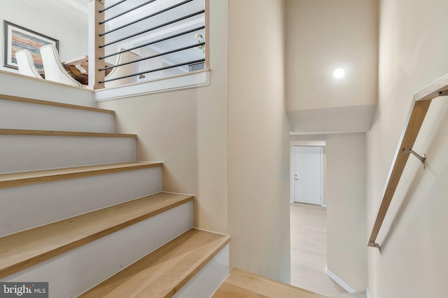 stairs with hardwood / wood-style floors