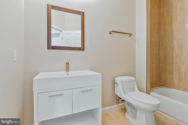 full bathroom with hardwood / wood-style floors, vanity, shower / bathtub combination, and toilet