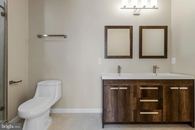 bathroom featuring tile patterned flooring, vanity, and toilet