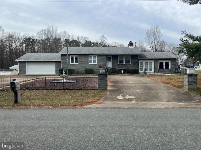 ranch-style home featuring a garage and a front lawn