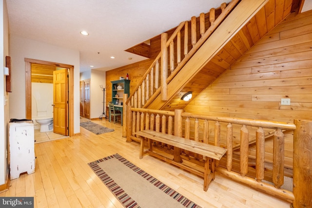 hall featuring wood walls and light hardwood / wood-style flooring