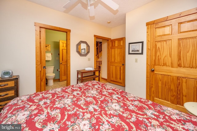 bedroom with a textured ceiling, ensuite bath, ceiling fan, and light tile patterned flooring