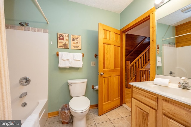 full bathroom featuring tile patterned flooring, shower / bath combination, a textured ceiling, toilet, and vanity